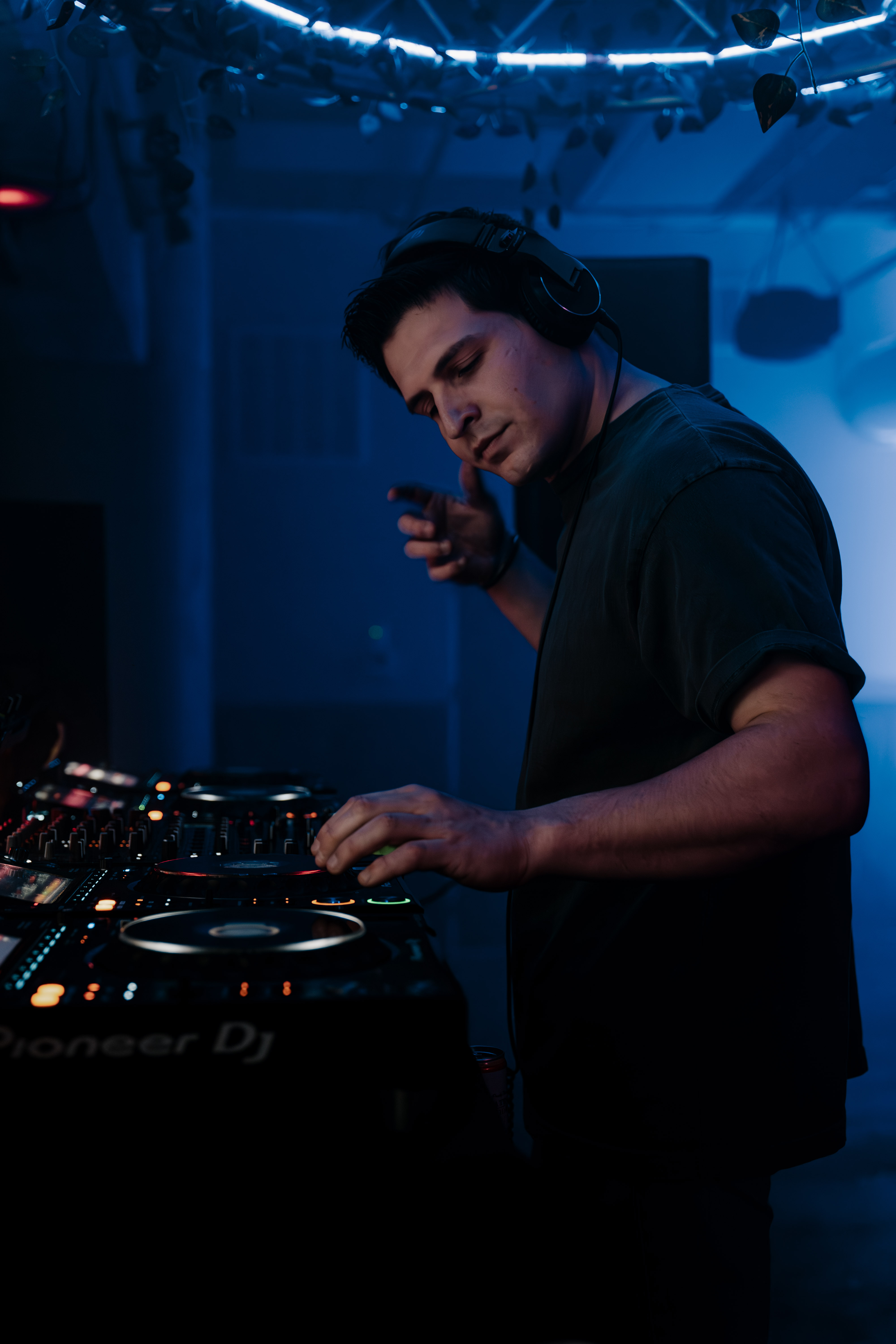 DJ CAM mixing at Riff City under blue club lighting